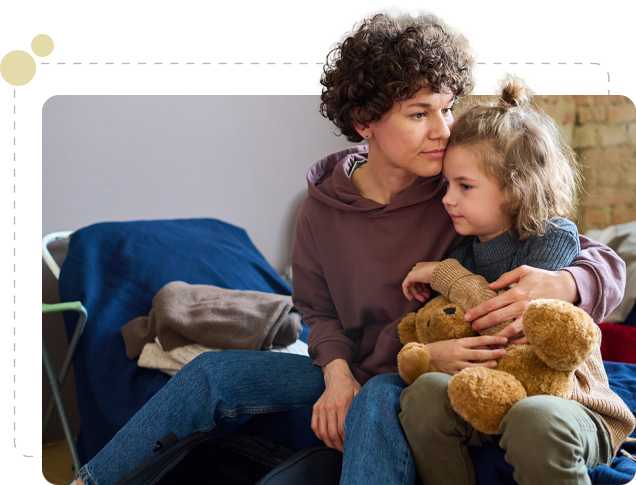 Woman comforting child with teddy bear.