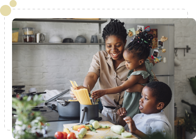 A woman and two children in the kitchen cooking.